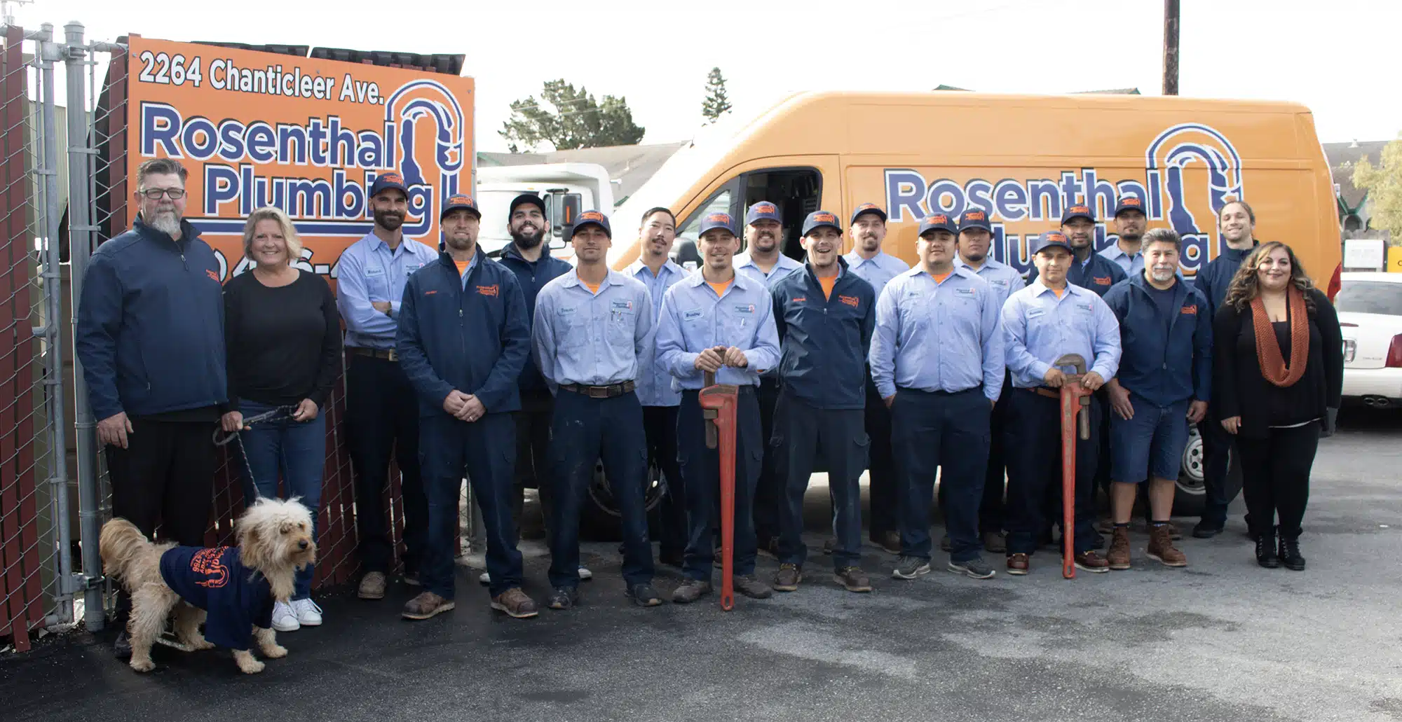 Rosenthal team in front of logo can and sign.